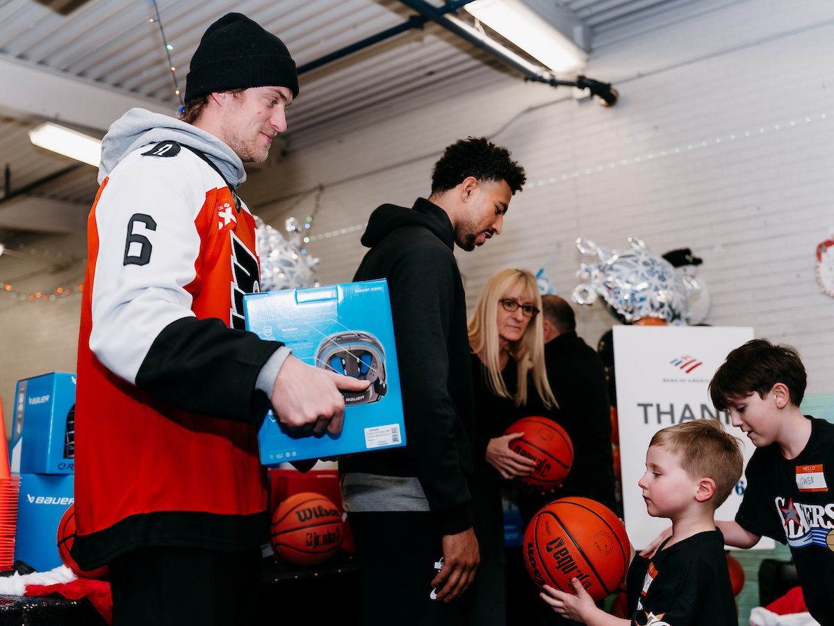 Travis Sanheim and Quentin Grimes deliver $15,000 worth of donated hockey and basketball equipment to kids at the Scanlon Recreation Center in Kensington.