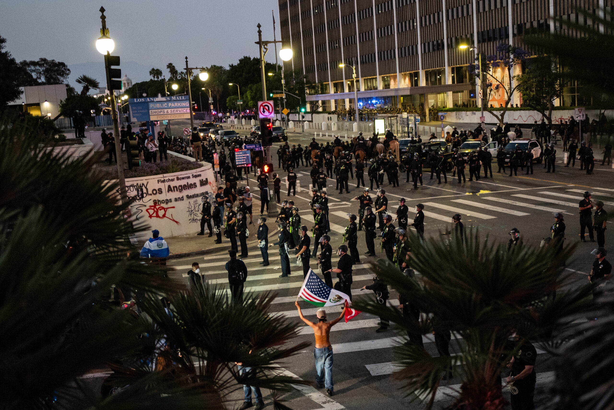 Law enforcement officers stand guard outside a detention center in Los Angeles on June 10, the day a curfew took hold following clashes in days prior between protesters and law enforcement.