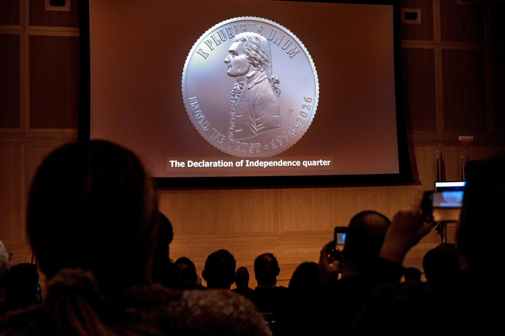 The obverse of the new Declaration of Independence quarter with Thomas Jefferson is shown on screen as the U.S. Mint unveils new coins for the Semiquincentennial at the National Constitution Center in Philadelphia Wednesday night. The reverse features the Liberty Bell.