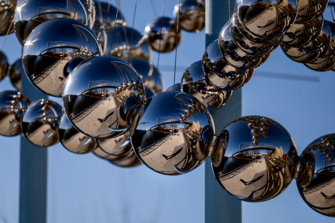 Seeing the Ben Franklin Bridge reflected by steel spheres