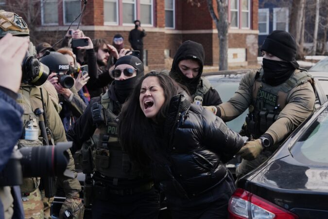 Federal immigration agents filmed dragging a woman from her car in Minneapolis