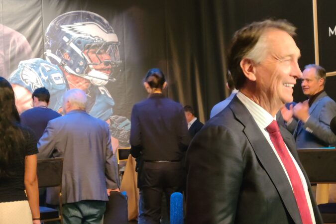 Saquon Barkley looms in the backround as NBC's Cris Collinsworth speak to reporters at a media event in New York City on Wednesday, Jan. 7, 2026.