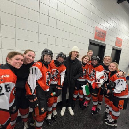 Flyers center Trevor Zegras (center) stops by a Philadelphia Liberties practice at the Flyers Training Center.