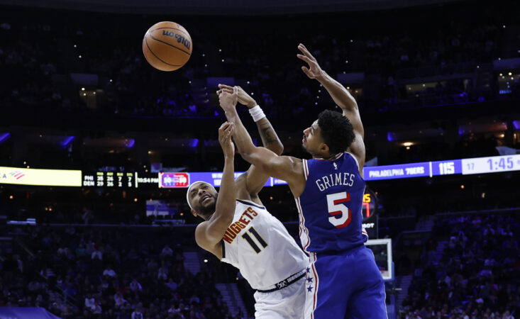 Sixers guard Quentin Grimes loses the basketball while being defended by Nuggets guard Bruce Brown in overtime on Monday.