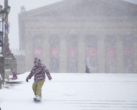 FILE Jan. 23, 2016 - Alex Yhr, 26, snow boards down the steps in front of the Philadelphia Museum of Art with his friend Miheer Pujara in Philadelphia, Saturday, Jan. 23, 2016. The two medical school student studying at Thomas Jefferson University decided to snow board the steps after seeing youtube videos of people sledding there last year.