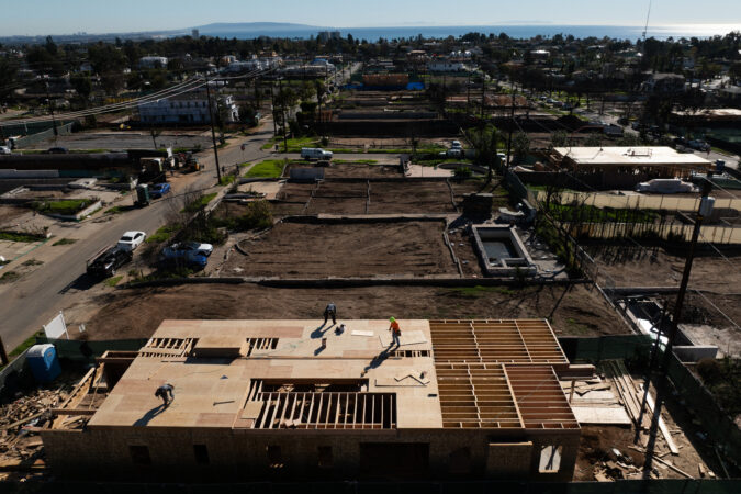 An aerial view shows houses being rebuilt on cleared lots months after the Palisades Fire, Dec. 5, 2025, in the Pacific Palisades neighborhood of Los Angeles. (AP Photo/Jae C. Hong)