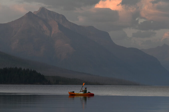 A boater floats on Lake McDonald in Glacier National Park in Montana.