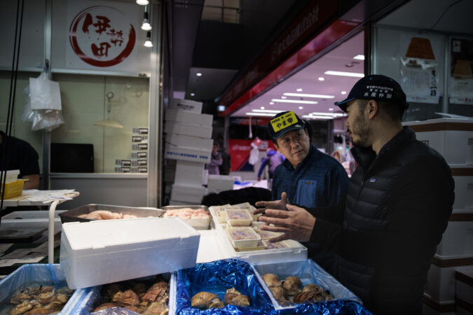 Hirokatsu Takeda talks with Jesse Ito in a stall at Toyosu Market on Tuesday, Nov. 4, 2025, in Tokyo, Japan.