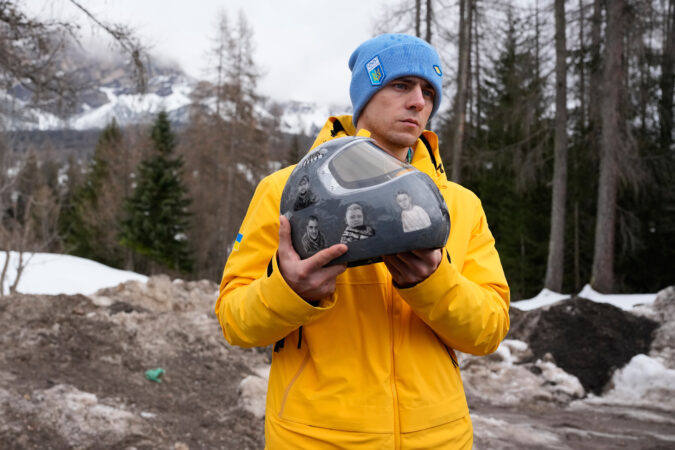 Ukrainian skeleton athlete Vladyslav Heraskevych holds his crash helmet outside the sliding center at the 2026 Winter Olympics in Milan, Italy.