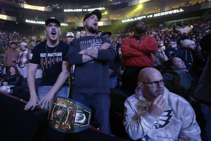 (Front row left-right) Logan Gipe, Steve Harper, and Jim Gottshall of Carlisle, Pa. brought an Eagles championship belt to BKFC's KnuckleMania V at the Wells Fargo Center on January 25, 2025.