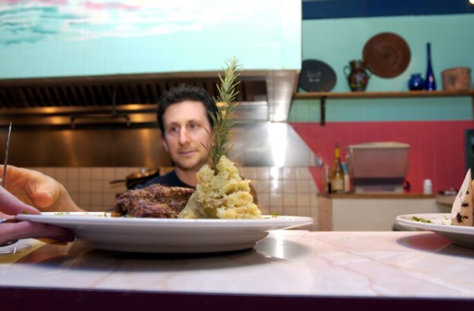 Rich Landau, chef and owner of Horizons Cafe in Willow Grove, overseeing a pecan-and-sage baked seitan dish leaving the kitchen on Jan. 7, 2003.
