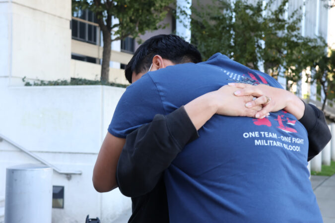 Julio Peña Jr. hugs his stepmother, Lydia Romero, outside an immigration detention facility in downtown Los Angeles as they try to get information about his father, Julio Cesar Peña, who was detained by Immigration and Customs Enforcement in front of his Glendale, Calif., home in December.
