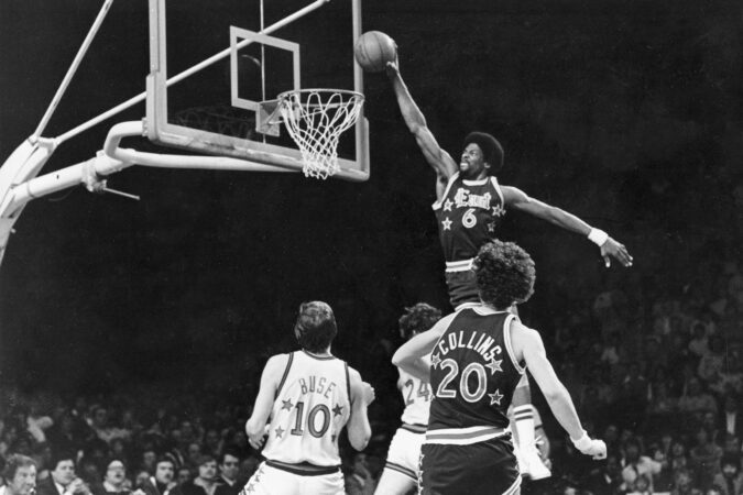 The Sixers' Julius Erving dunks the ball through the basket over Chicago Bulls' Artis Gilmore during first half of game in Philadelphia, Pa., Jan. 3, 1979.