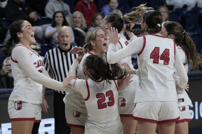 The Archbishop Carroll girls celebrate after winning the Catholic League championship, beating Cardinal O’Hara at the Palestra.