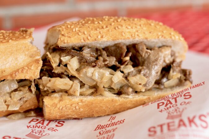 A new-school cheesesteak on a seeded roll at Pat's King of Steaks.
