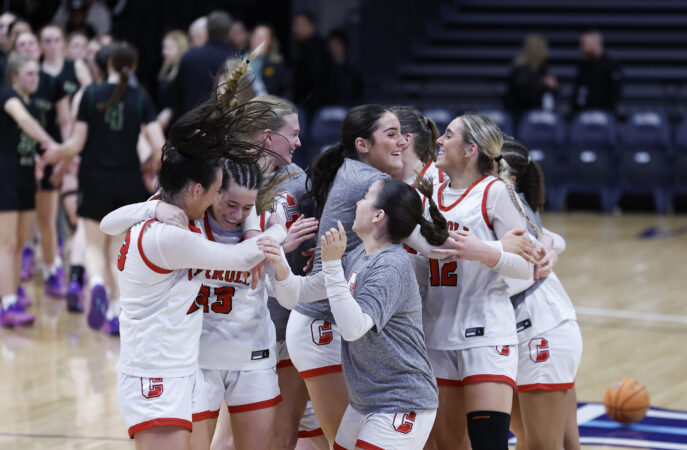 Members of the Archbishop Carroll High team celebrate after beating Archbishop Wood in the Catholic League girls' basketball semifinals at Villanova on Monday.