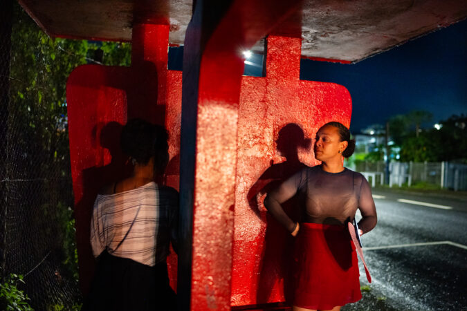 Elaine Monroe, 28, talks to a sex worker on a street in Suva, Fiji's capital, in December. Monroe is an injecting drug user, former sex worker, and a community leader who is part of a peer-led initiative to educate other users on safe needle use and safe drug practices.