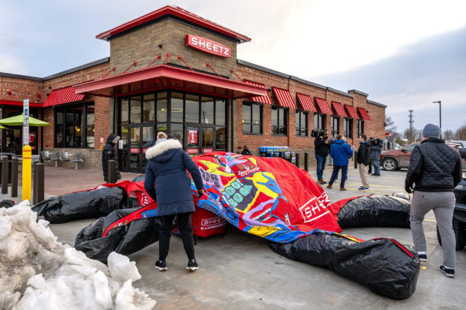 Workers set up inflatable tents as the first Sheetz store opens in the Philadelphia suburbs Thursday in Limerick Township.