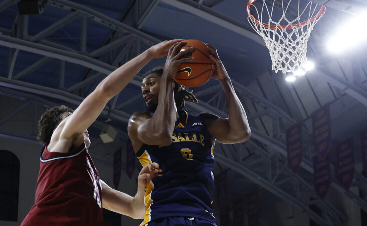La Salle forward Justin Archer (right) battles with Penn center Dalton Scantlebury at the Palestra earlier this season.