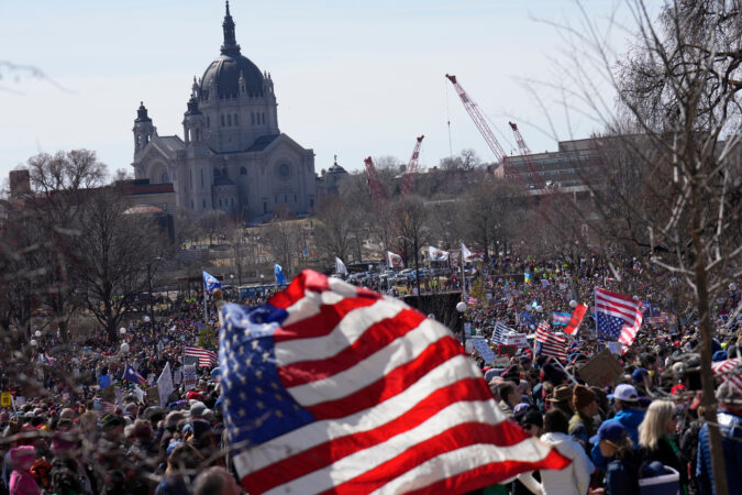 People take part in a "No Kings" protest Saturday in St. Paul, Minn.