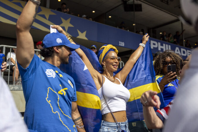 Juliska Koolman, of Atlanta, Ga., is cheering on Curaçao with her son Matthew Hernandez, of Newark, N.J., (left), at the start of the Curaçao vs Ivory Coast on Thursday.