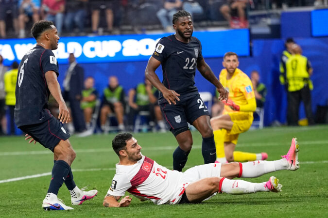 Auston Trusty (left) and Mark McKenzie (center) watching Turkey's Kaan Ayhan score the last-second game-winning goal.