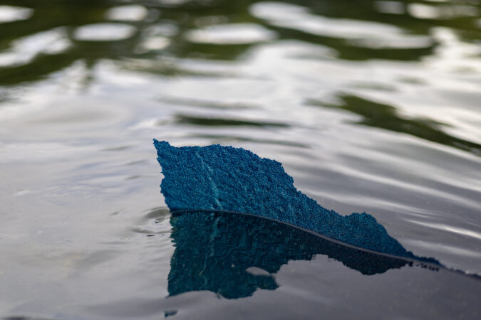 The blue paint is peeling off the Reflecting Pool