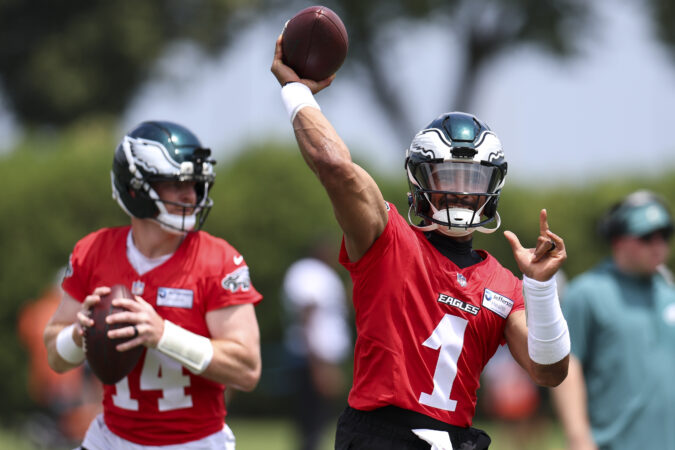 Quarterbacks Andy Dalton (left) and Jalen Hurts work out during mandatory minicamp.