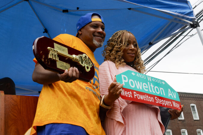 Antoine Mapp, the director of the West Powelton Steppers and Drumline, receives the key to the city by council member Jamie R. Gauthier on Saturday. The event honored the organization with a street renaming ceremony.