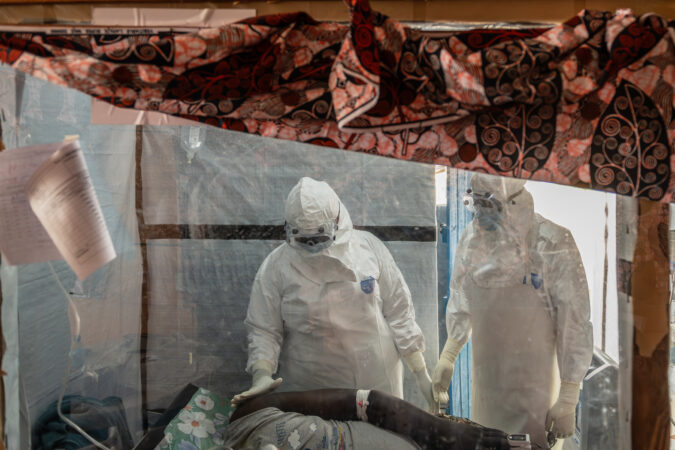 Health workers tend to an Ebola patient at the Rwampara Treatment Center in Ituri, Congo, on June 18.