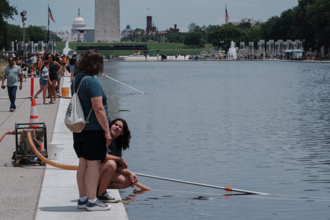 Visitors look at the Lincoln Memorial Reflecting Pool Sunday, June 21, 2026, on the National Mall in Washington.