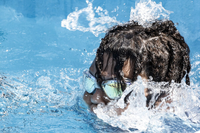 Makhi Miller, 11, enjoys the water spout on a 90-degree day on the first day the pools opened at the Chew Pool in June.