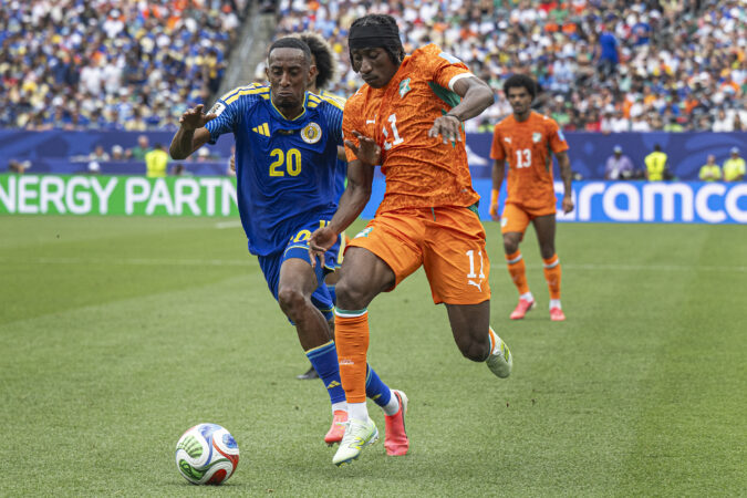 Ivory Coast's Yan Diomande (right), dribbles past Curaçao’s Joshua Brenet during the first half of Thursday's Group E finale at Philadelphia Stadium.