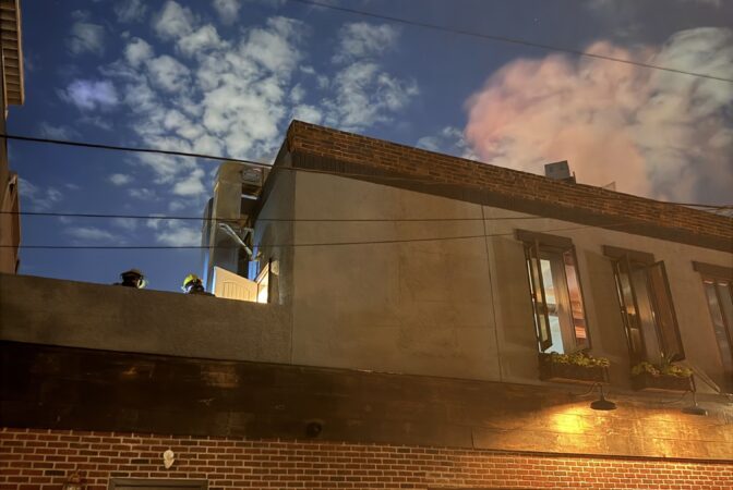 Firefighters work on the roof of Ember & Ash on June 24, 2026.
