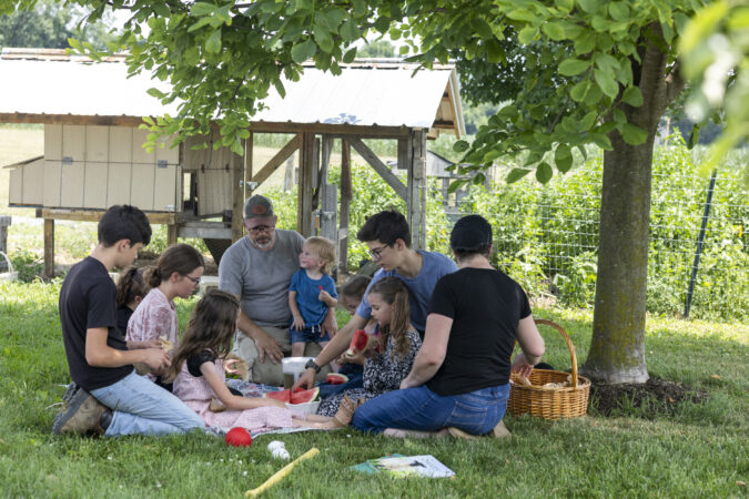 Shawn and Gina King eat lunch outside with their eight children at their home outside New Holland after recovering from measles.