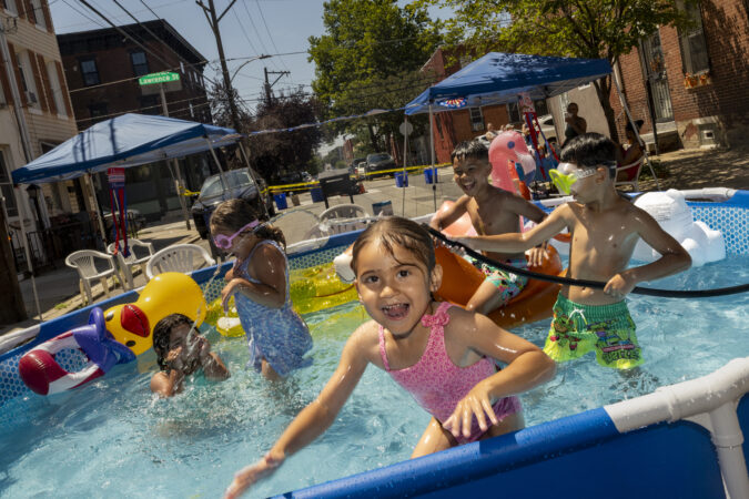 Children play in an above-ground pool at a block party in the Ludlow section of Philadelphia on Saturday.