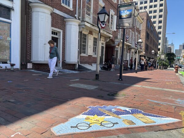 A vinyl mosaic decal just outside of Franklin Court in Old City marks the site as a stop on the Path to Democracy during the trail's beta testing phase. A QR code on the decal takes visitors to an accompanying website about Franklin Court and the path itself.