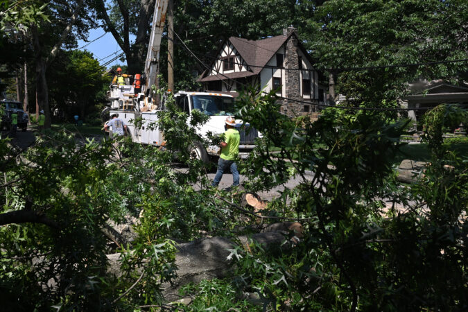 Utility workers restore power on Beacom Lane in Merion Station on Monday.