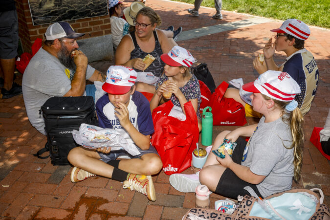 The Edwards family enjoy their free hoagies and snacks at Independence Mall during the Wawa Hoagie Day on Wednesday. From left to right: Justin, Liam, Brittany, Lucy, Owen, and Skylar Cook