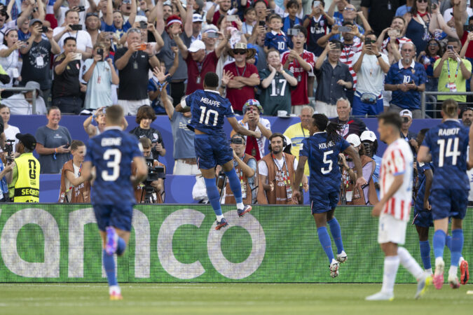 France's Kylian Mbappé celebrates after scoring on a penalty kick in the second half of a FIFA World Cup Round of 16 soccer match against Paraguay on Saturday.