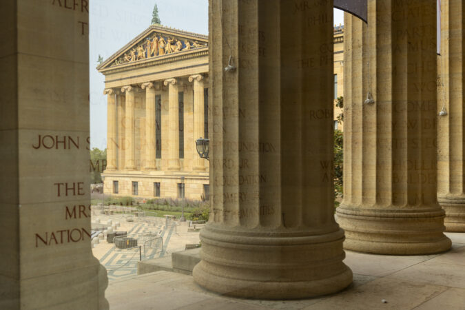 The exterior of the Philadelphia Museum of Art is reflected through the windows of the front entrance lobby on Tuesday, July 14, 2026, in Philadelphia.