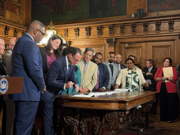 Gov. Josh Shapiro, flanked by fellow state Democrats, signs the 2026-27 Pennsylvania state budget in Harrisburg, Pa. on Sunday, July 12, 2026.