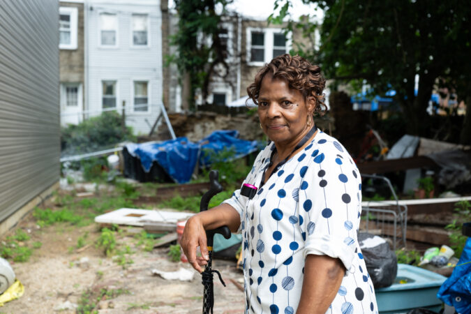 Delores Lawrence poses for a portrait in the backyard of her home in Germantown earlier this month. Lawrence says the construction of an affordable housing development next door — owned by the politically connected Danilo A. Burgos — has damaged her property.