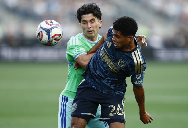 Union defender Nathan Harriel goes after the ball as Seattle Sounders forward Paul Rothrock defends during the first half on Saturday.