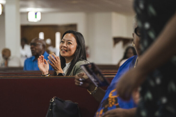 Francesca Hong, a Wisconsin state representative, claps to a song at the St. Paul Baptist Church in Racine on Sunday.