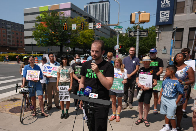 Gabriel Straus, who serves as Vice-Chairperson and a board member for Philly Bike Action!, speaks at a rally to advocate for safer bike infrastructure at 34th and Market Streets.