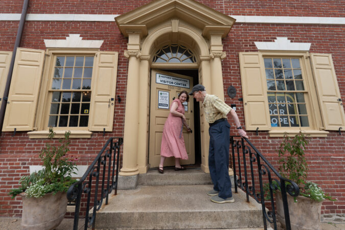 Kaila Temple, curator, opens the front door for Irvin Miller, at the new Germantown visitor center at the Germantown Historical Society building.